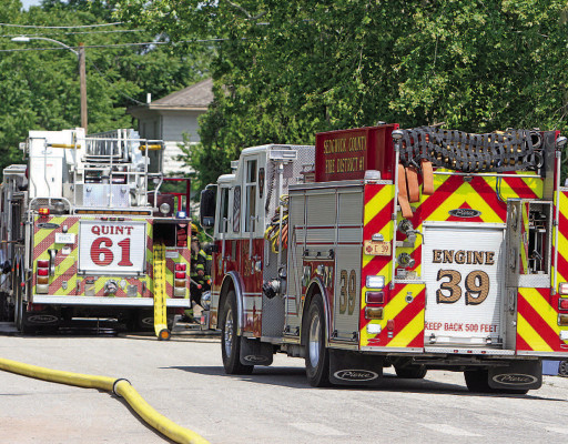 Fire crews from Cheney and Sedgwick County respond to a house fire near Main Street and Fifth Avenue in Cheney on Sunday. Three dogs died as a result of the fire, but there were no injuries to people. Travis Mounts/TSnews