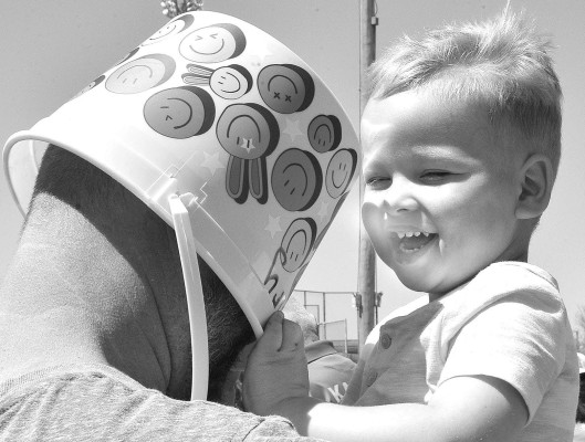 Henry Gish plays with his dad, Jared, during the Goddard Easter egg hunt on Saturday afternoon. Dale Stelz/TSnews