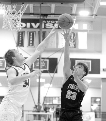 Goddard’s Jake Jasnoski attempts to block a shot by Eisenhower’s Derek Morgan. Jasnoski was one of three Lions to score in double figures in a win over the Tigers. Stephanie McKennon/TSnews
