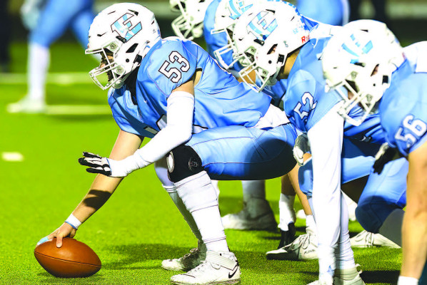 Tigers’ center Jake Truzzolino and the offensive line get ready for a play during Eisenhower’s home playoff game against the Hays Indians. The teams have faced off five times in the past six years. Matt Bucher/Ginger Viking Fotos
