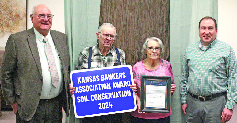 Wavern and Earlynne Becker, center, were honored with the Banker’s Association Award at last month’s Sumner County Soil Conservation banquet, held at the Raymond Frye Complex in Wellington. Also pictured are Sumner County Conservation District chair Doug Hisken, left, and banker representative Phil White. Travis Mounts/TSnews