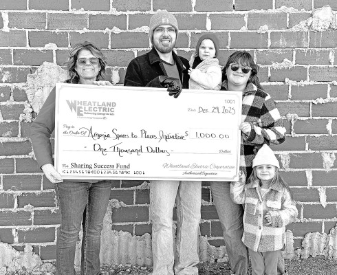Argonia Spaces to Places Initiative, represented by Sarah Vineyard (left) and local artist Daniel Thompson (middle) and his family – Micah, Naomi, and Anneliese – was awarded a Wheatland Electric Sharing Success grant to be used to help fund a community mural on the north side of the R. Greene Photography Studio as part of Argonia’s ongoing revitalization efforts.