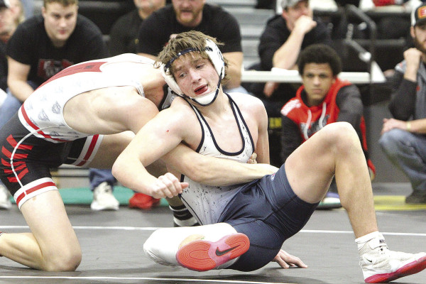 Dylan Hanna escapes from El Dorado’s Beau Hall during a match Saturday at regional wrestling in Andale. He beat Hall to qualify for 4A State, and then won his next match to place third at 138 pounds. Travis Mounts/TSnews