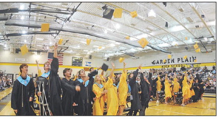 ABOVE: Garden Plain High School seniors celebrate their graduation at Sunday’s ceremony. BELOW LEFT: Jaxon Bridwell gives a hug to his father and principal, Doug Bridwell, at Goddard High’s graduation Saturday at Park City Arena. BELOW RIGHT: Natalee Lempke celebrates during Eisenhower High’s commencement at Park City Arena. Dale Stelz and Stephanie McKennon/TSnews