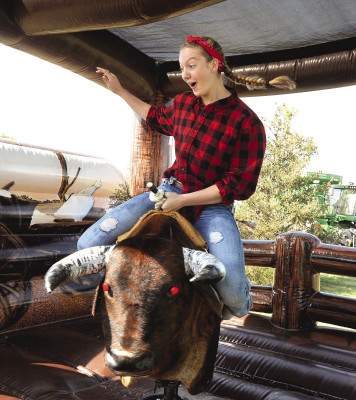 Madeline Wilson takes a ride on the mechanical bull last Saturday at the Goddard Fall Festival. Last weekend’s event enjoyed favorable weather. See more photographs on Page A3. Dale Stelz/TSnews