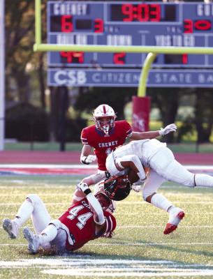 Cheney’s Levi Self pulls down a Holcomb ball carrier during the first half of the Cardinals’ home game on Friday. The Cardinals are beginning defense of their first-ever State championship in football. Andrea McDaniel/TSnews