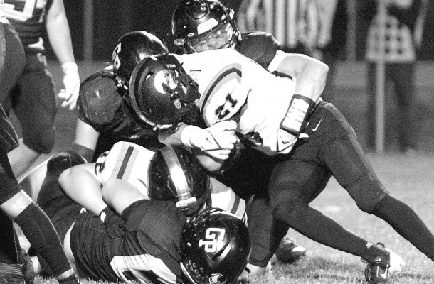Multiple Garden Plain defenders team up to drag down a Beloit ball carrier during Friday’s home victory. Travis Mounts/TSnews