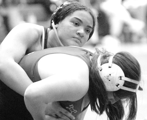 Elayna Evans works to take down an opponent at last month’s Class 6A regional in Wichita. She won a regional title at 190 pounds, and then swept through 6A State to complete a perfect season with a State title. Travis Mounts/TSnews