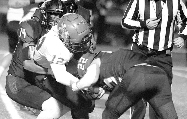 Campus Colts Jaxon Denard (14) and Vincent Pirone (22) tackle a Hutchinson runner during last Friday’s homecoming game in Haysville. Stephanie McKennon/TSnews