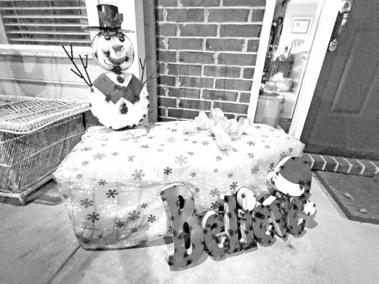 Something as simple as a bale of hay (wrapped as a giant present and supporting some metal yard art – Kim's idea) can serve well for three occasions on the front porch: Fall, Halloween and Christmas. Next, it will turn into garden mulch in the spring. Paul Rhodes/TSnews