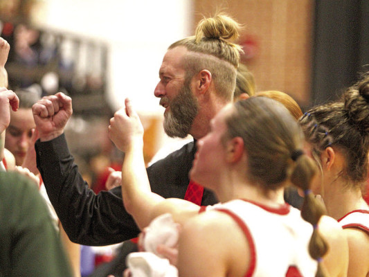 Morgan Grippin visits with the Argonia Raiders during a timeout at the recent South Central Border League girls basketball championship, which AHS won. Grippin holds the rare position of head coach of both the girls and boys teams at the same school. Travis Mounts/TSnews