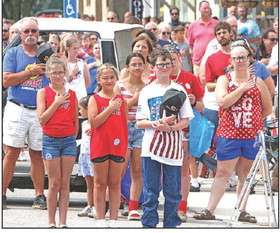 Independence Day celebrations took place Saturday in Clearwater, Garden Plain, Goddard and Haysville. Above, parade attendees in Garden Plain pause for the singing of the national anthem. At right, a young parade participant in Haysville dresses up as the Statue of Liberty, perhaps the country’s greatest symbol of freedom. Garden Plain and Haysville have annual events that last all day and include parades and fireworks shows. Travis Mounts and Stephanie McKennon/TSnews