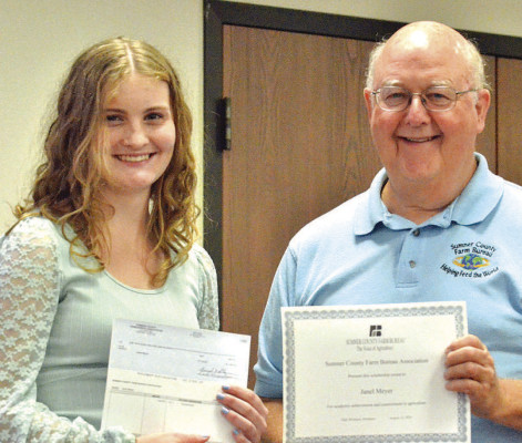Sumner County Farm Bureau Association president Dale Weishaar presents Janel Meyer with the association’s annual scholarship. The $1,000 award is helping Meyer with her studies at Pittsburg State University in southeast Kansas. Paul Rhodes/TSnews