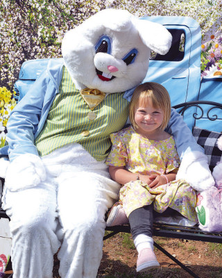 Elizabeth Etheridge snuggles up to the Easter bunny during Saturday’s egg hunt in Goddard. See more photos on Page B1. Dale Stelz/TSnews