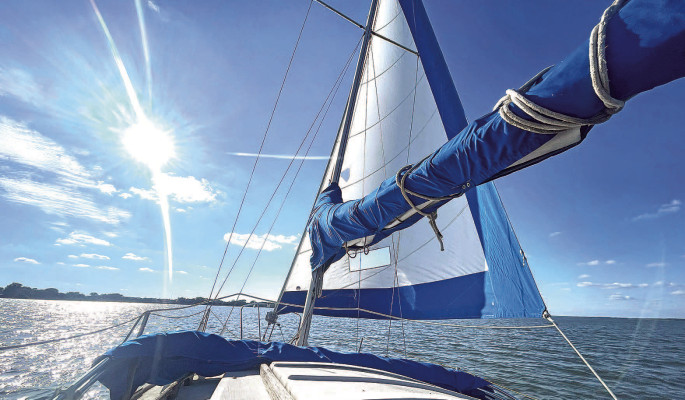 A sailboat cruises along the water at Cheney Lake during Sunday’s open house at the Ninnescah Sailing Association. Travis Mounts/TSnews