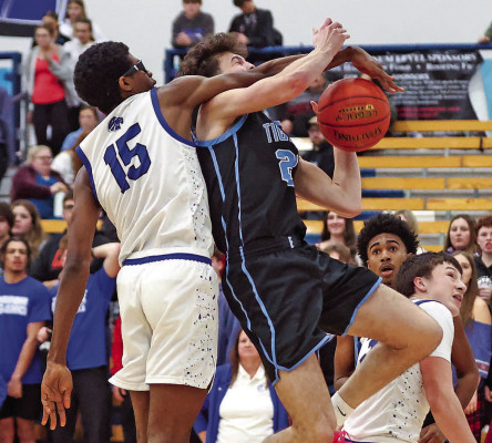 Goddard’s Yabet Avery tries to swat away a shot by Eisenhower’s Cooper Rohr. Avery was called for a foul. Eisenhower won by 13 points. Matt Buchar/Ginger Viking Fotos