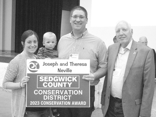Joseph and Theresa Neville were presented with a conservation award for a cover crop project. They farm in the Andale and Goddard area.