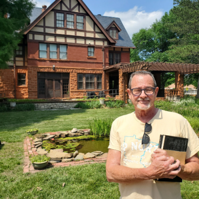Times-Sentinel publisher Paul Rhodes in front of the William Allen White home in Emporia. He's holding a copy of White's biography that he was given on the grounds. Kim Swansen/TSnews