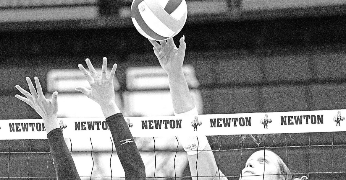 Mindy Tillotson (8) of Goddard goes up to block a ball from Eisenhower’s Callie Gumm during the teams’ recent head-to-head match in Newton. Preston Barger/Contributed photo