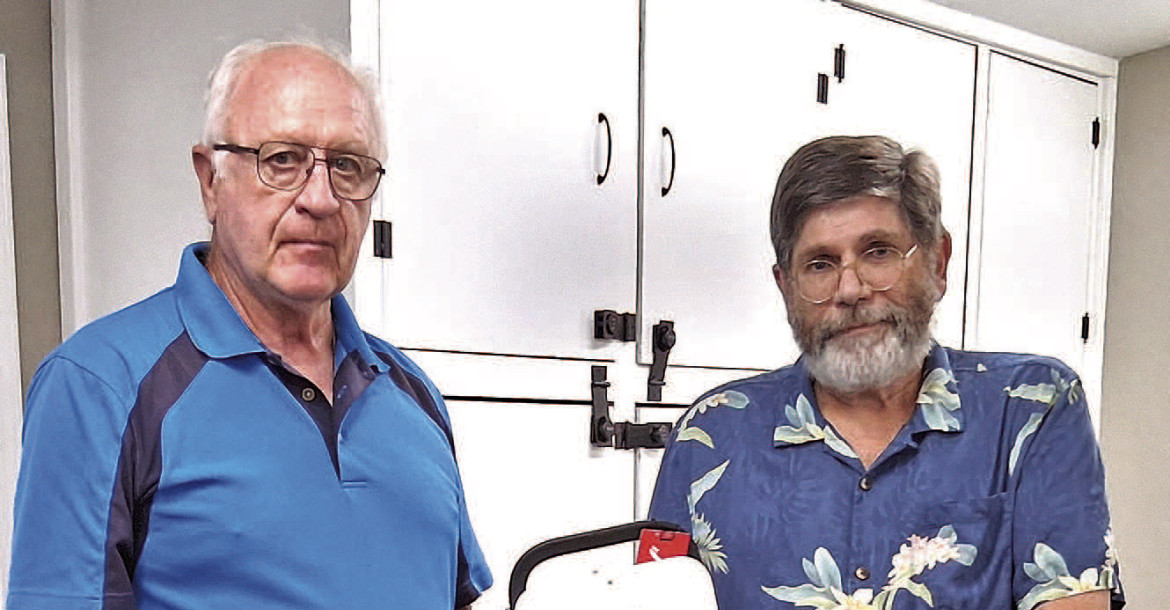 Dennis Long, right, presents a new AED to Cheney Senior Center vice president Steve Garton. The donation was made at the center’s August potluck. Contributed photo