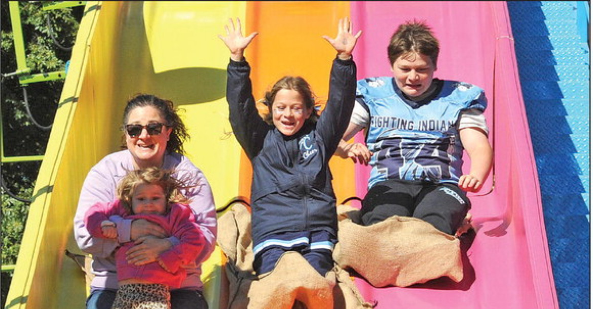 Members of the Winterscheidt family whiz down the WEEE Carnival big slide Saturday at the Clearwater Fall Festival. The event took place over the weekend, with many people taking advantage of the good weather. See more photos on Page A8. Dale Stelz/TSnews