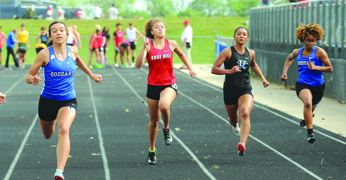 Goddard runners Leah LaPlant, left, and Monty Ray, right, and Eisenhower runner Julissa Lawrence, second from right, reach the finish line during a preliminary head of the 100 meters during Goddard’s home track and field meet. It was held last Thursday. Subscribers can see additional photos online at www.tsnews.com. Dale Stelz/TSnews