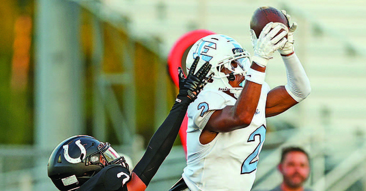 Braylon Lies makes a catch for the Eisenhower Tigers during their come-frombehind win over Campus in Haysville. The Colts’ Emauni Buncome defends Lies. Matt Bucher/Ginger Viking Fotos
