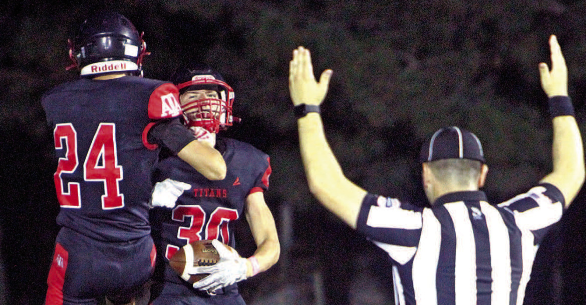 Konner Nelson (24) and Zach Morrison celebrate Morrision's second-quarter touchdown in Argonia-Attica's homecoming win over Norwich. Travis Mounts/TSnews